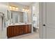 Bathroom vanity with double sinks and traditional-style dark wood cabinets at 4624 Leon De Oro Dr, Las Vegas, NV 89129