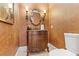 Elegant powder room featuring a vanity with a decorative mirror and sconce lighting at 4624 Leon De Oro Dr, Las Vegas, NV 89129