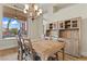 Comfortable dining space with wood table, cabinetry, and natural light at 4624 Leon De Oro Dr, Las Vegas, NV 89129