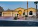 Charming home featuring a manicured front yard, three-car garage, and elegant entrance at 4624 Leon De Oro Dr, Las Vegas, NV 89129