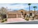 Charming home featuring a three-car garage and desert landscaping at 4624 Leon De Oro Dr, Las Vegas, NV 89129