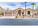 Exterior of home features desert landscaping, palm trees, and a three car garage at 4624 Leon De Oro Dr, Las Vegas, NV 89129