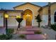Beautiful home exterior showcasing stone steps, desert landscaping, and a decorative front gate at 4624 Leon De Oro Dr, Las Vegas, NV 89129