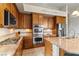 Modern kitchen showcasing stainless steel appliances, granite countertops, and custom wood cabinetry at 4624 Leon De Oro Dr, Las Vegas, NV 89129