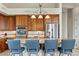 Modern kitchen boasts stainless steel appliances, a center island with seating, and warm wood cabinetry at 4624 Leon De Oro Dr, Las Vegas, NV 89129