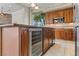 Gourmet kitchen with stainless steel appliances, custom cabinetry, and a wine fridge at 4624 Leon De Oro Dr, Las Vegas, NV 89129