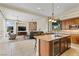 Open-concept kitchen overlooking a Gathering room with stone fireplace and backyard views at 4624 Leon De Oro Dr, Las Vegas, NV 89129