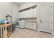 Spacious laundry room with lots of cabinets and tile floors at 4624 Leon De Oro Dr, Las Vegas, NV 89129