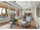 Spacious living room with pool views, wood floors, and comfortable seating arrangement at 4624 Leon De Oro Dr, Las Vegas, NV 89129