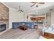 Open-concept living room with stone fireplace seamlessly flows into the kitchen at 4624 Leon De Oro Dr, Las Vegas, NV 89129