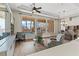 Light-filled living room with a view of the pool and backyard through large windows at 4624 Leon De Oro Dr, Las Vegas, NV 89129