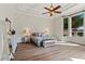 Bedroom featuring a large window, wooden floor, and stylish decor at 4624 Leon De Oro Dr, Las Vegas, NV 89129