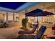Serene outdoor patio with comfortable seating, overlooking a manicured backyard and providing a peaceful retreat at 4624 Leon De Oro Dr, Las Vegas, NV 89129