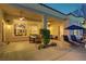 Relaxing covered patio with outdoor seating, offering a tranquil view of the backyard and beautifully landscaped surroundings at 4624 Leon De Oro Dr, Las Vegas, NV 89129