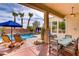 Relaxing covered patio with dining, overlooking a pool with a cascading water feature at 4624 Leon De Oro Dr, Las Vegas, NV 89129