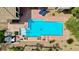 Aerial view of a sparkling blue pool surrounded by a patio and desert landscaping at 4624 Leon De Oro Dr, Las Vegas, NV 89129