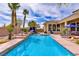 Inviting backyard pool featuring a waterfall and comfortable lounge area for relaxation and entertainment at 4624 Leon De Oro Dr, Las Vegas, NV 89129