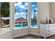 Bright room with large windows offering a view of the pool and palm trees in the backyard at 4624 Leon De Oro Dr, Las Vegas, NV 89129