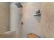 Modern shower with stone-look walls, bench, rainfall shower head, and recessed niche at 4624 Leon De Oro Dr, Las Vegas, NV 89129