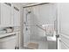 Bright shower featuring a sliding glass door, handheld shower head and built-in shelving at 4624 Leon De Oro Dr, Las Vegas, NV 89129