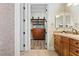 A glimpse into an organized walk-in closet with custom wooden shelving and drawers, maximizing storage at 4624 Leon De Oro Dr, Las Vegas, NV 89129