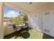 Cozy balcony with artificial turf, a small table with chairs, and exterior storage closets at 4865 S Torrey Pines Dr # 206, Las Vegas, NV 89103