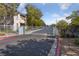 Community gate and fence with mature trees and landscaping at 4865 S Torrey Pines Dr # 206, Las Vegas, NV 89103