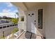 Front door of the condo with a white door, window, and a welcome mat on the porch at 4865 S Torrey Pines Dr # 206, Las Vegas, NV 89103