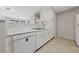 Well-maintained kitchen with white cabinets, matching dishwasher, sink, and tile flooring at 4865 S Torrey Pines Dr # 206, Las Vegas, NV 89103