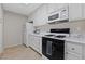 Bright kitchen equipped with white cabinets, essential appliances including a microwave, and ample counter space at 4865 S Torrey Pines Dr # 206, Las Vegas, NV 89103