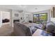 Comfortable living room featuring neutral carpet, a fireplace, and sliding glass doors to a balcony at 4865 S Torrey Pines Dr # 206, Las Vegas, NV 89103