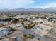 Expansive aerial view of the property showcasing the neighborhood, houses, and the mountain range in the background at 5081 Riata Pl, Pahrump, NV 89060