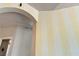 Close up view of an archway with striped walls and a glimpse into another room at 5081 Riata Pl, Pahrump, NV 89060