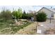 Spacious backyard featuring a windmill, grass and various trees, with the house on the right at 5081 Riata Pl, Pahrump, NV 89060