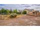 Backyard view with desert landscaping, scattered greenery, and a glimpse of the house at 5081 Riata Pl, Pahrump, NV 89060