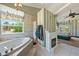 Bright bathroom features a standalone tub with fireplace and a great backyard view at 5081 Riata Pl, Pahrump, NV 89060