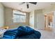 Bedroom featuring neutral tones, tiled flooring, a ceiling fan, and a bright window at 5081 Riata Pl, Pahrump, NV 89060