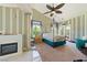 Cozy bedroom with unique accent wall, fireplace, ceiling fan, and access to the backyard at 5081 Riata Pl, Pahrump, NV 89060