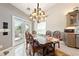 Charming dining area with elegant chandelier, tile floors, and access to the backyard at 5081 Riata Pl, Pahrump, NV 89060