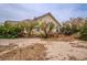 Home exterior with desert landscaping and mature trees in the front yard, with some bushes growing around it at 5081 Riata Pl, Pahrump, NV 89060