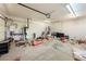 Garage with an open door, water heater, tools and other items scattered on the floor at 5081 Riata Pl, Pahrump, NV 89060