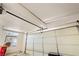 Garage door with automatic opener and track in a messy and unkempt condition at 5081 Riata Pl, Pahrump, NV 89060