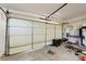 Garage with a large white door, water heater, and tools scattered around the floor at 5081 Riata Pl, Pahrump, NV 89060
