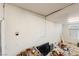 Garage wall with crack and electrical outlets, along with debris and various stored objects at 5081 Riata Pl, Pahrump, NV 89060