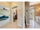 Hallway featuring tiled flooring connecting to the bedroom, laundry, and kitchen areas at 5081 Riata Pl, Pahrump, NV 89060