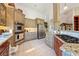 Spacious kitchen featuring stainless steel appliances, granite countertops, and tile flooring at 5081 Riata Pl, Pahrump, NV 89060