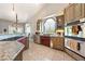 Well-lit kitchen featuring stainless steel appliances, tile flooring, and natural light at 5081 Riata Pl, Pahrump, NV 89060