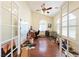 Sunlit office space with ceiling fan and arched windows, walls with damages at 5081 Riata Pl, Pahrump, NV 89060