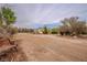 Street view of the home with a long dirt driveway and natural desert landscaping at 5081 Riata Pl, Pahrump, NV 89060