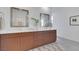 Bathroom with double vanity, square mirrors and neutral rug at 513 Monarch Ridge Ct, North Las Vegas, NV 89084